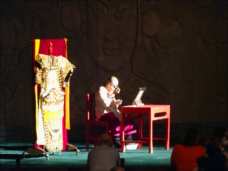 Actor applying makeup at Peking Opera