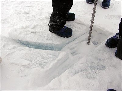 Drilling the sea ice to test the thickness